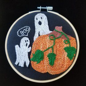 Pumpkin! Hand Embroidered with Orange floss, onto a Black canvas Fabric. 3.5in.